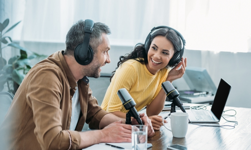 Two people recording a podcast in a studio.
