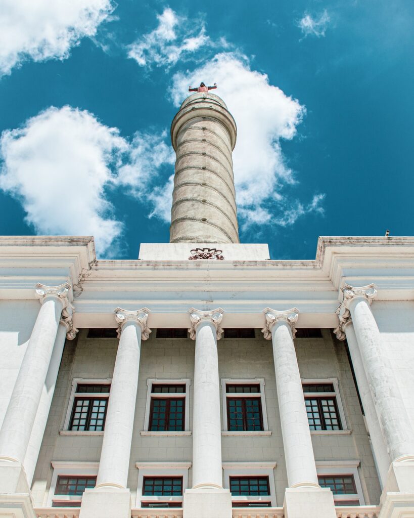 White building with tall tower and columns